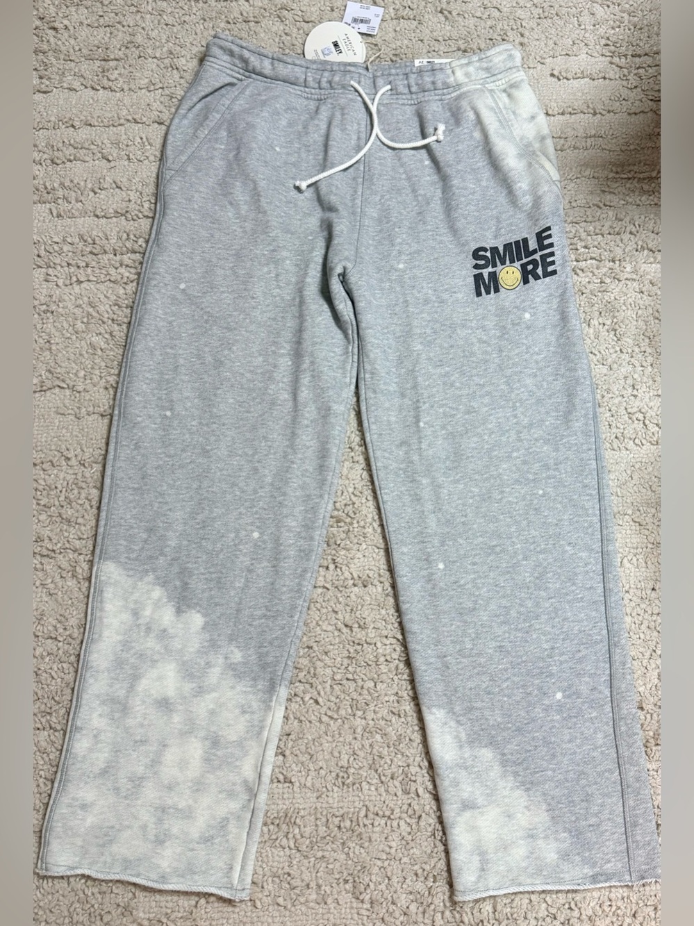 New American Eagle “Smile More"  distressed bleach wash open hem sweatpant L